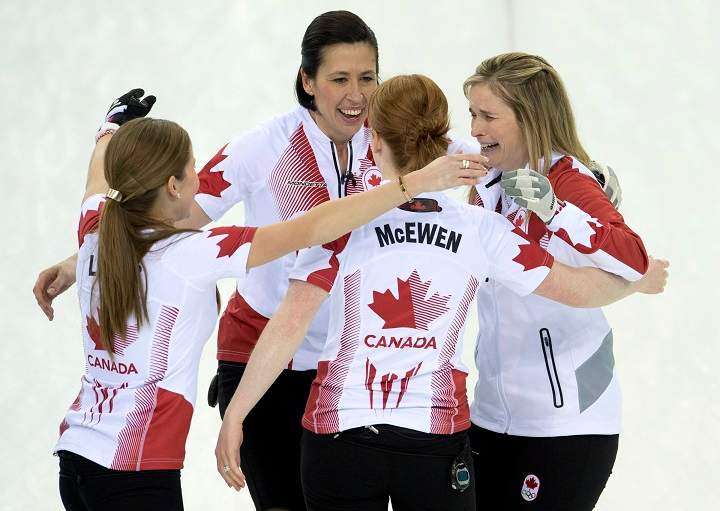 Canada skip Jennifer Jones (right) Dawn McEwen, Kaitlyn Lawes (left) and Jill Officer (back) celebrate after winning the gold medal during Olympic final curling action against Sweden at the Sochi Winter Olympics Thursday in Sochi, Russia.