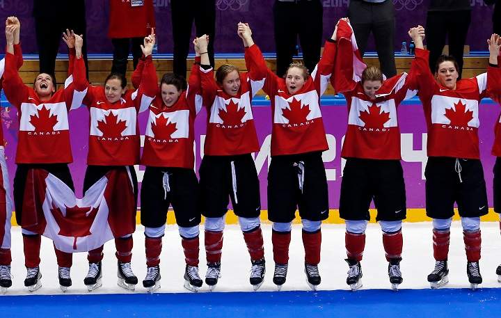 Members of Team Canada celebrate during the medal ceremony after the women\’s ice hockey tornament at the 2014 Winter Olympics, Friday, Feb. 21, 2014, in Sochi, Russia.