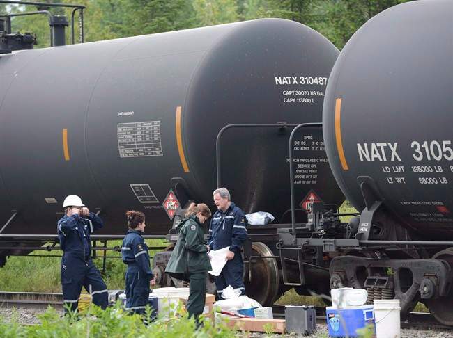 Investigators look over tanker cars pulled from the Lac-Megantic in Nantes, Que., on July 11, 2013.