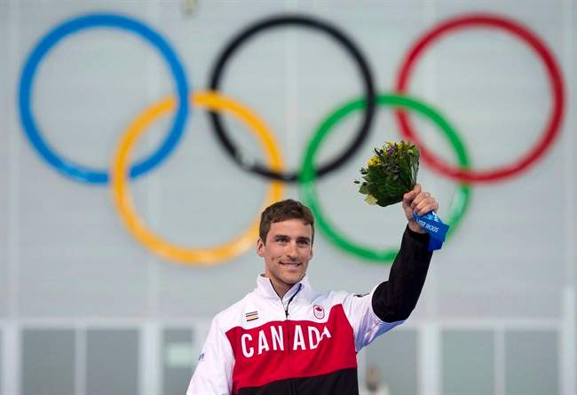 Canada's Denny Morrison stands on the podium Saturday February 15, 2014 in Sochi, Russia.