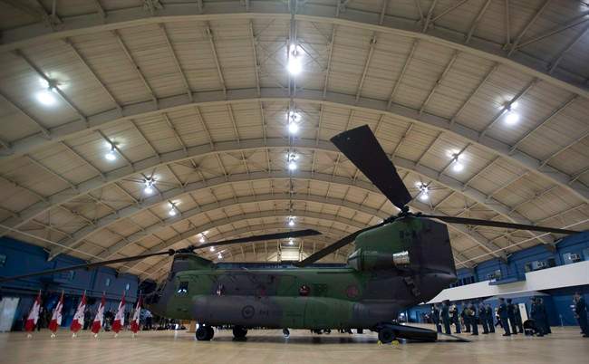 A new Chinook CH-147F helicopter sits in a hangar before an event June 27, 2013 in Ottawa.