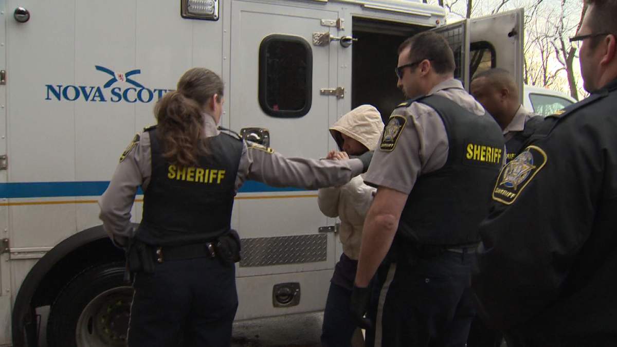 Henneberry wore a white jacket and kept her hood on as she tried to shield her face from media.