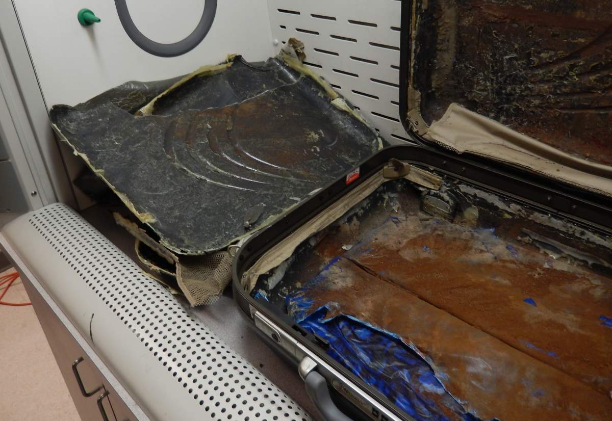 Seized suspected heroin and false-bottom suitcases used to conceal the narcotics.