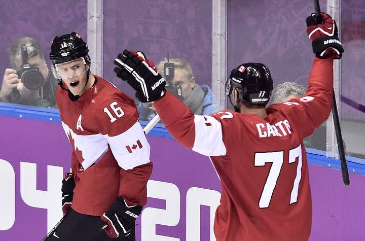 Canada's Jonathan Toews, left, celebrates his goal against Sweden with teammate Jeff Carter during first period action