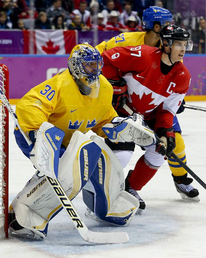 Canada forward Sidney Crosby, right, looks for a shot against Sweden goaltender Henrik Lundqvist during the second period