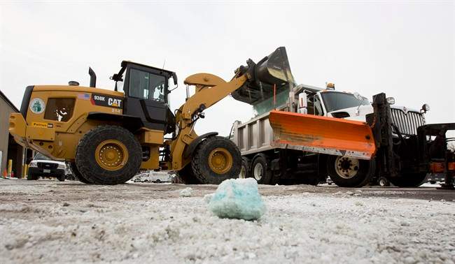 Road salt is loaded into a snow plow truck equipped with a salt spreader at the public works facility in Glen Ellyn, Ill., on Tuesday, Feb. 4, 2014.