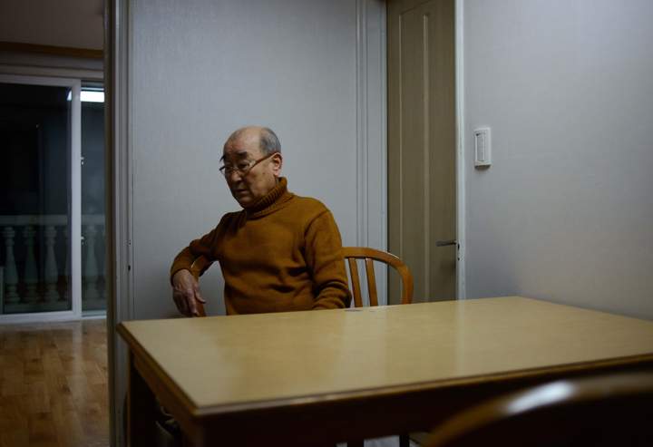 Kim Dong-Bin, one of 82 South Koreans selected to attend family reunions with the North, sits in his hotel room the night before the meeting, in the eastern port city of Sokcho on February 19, 2014.