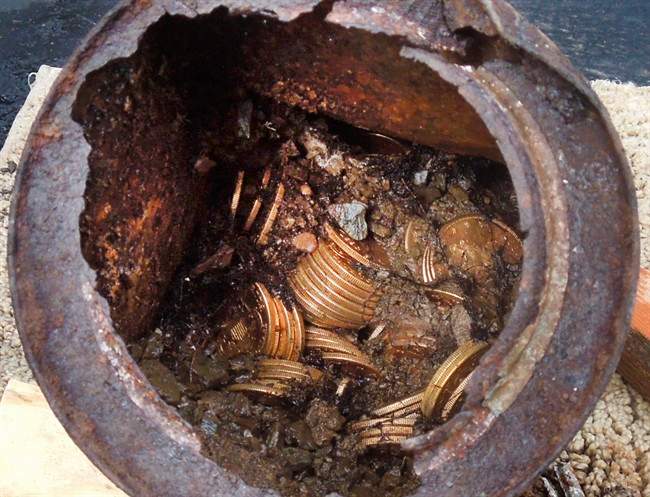 This image provided by the Saddle Ridge Hoard discoverers via Kagin's, Inc., shows one of the six decaying metal canisters filled with 1800s-era U.S. gold coins unearthed in California by two people who want to remain anonymous. 