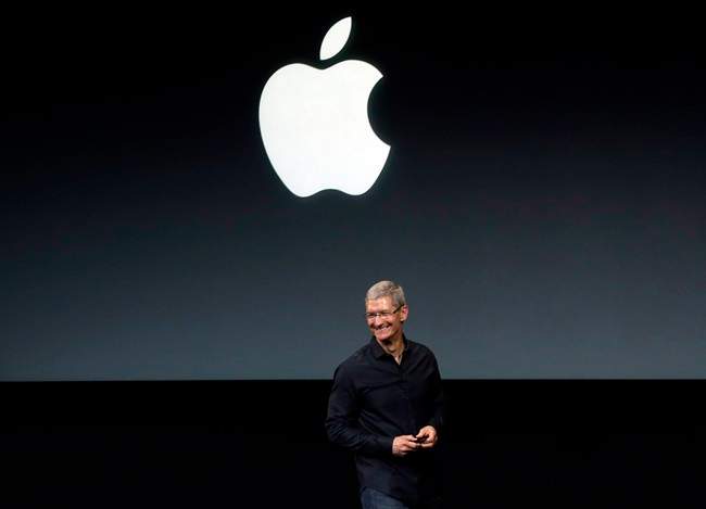In this Tuesday, Sept. 10, 2013, file photo, Apple CEO Tim Cook speaks on stage before a new product introduction in Cupertino, Calif. 