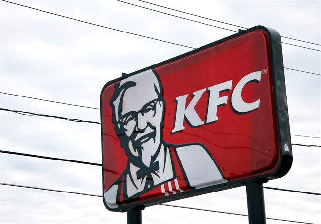In this Friday, Jan. 31, 2014, photo, a KFC sign hangs in Saugus, Mass. 