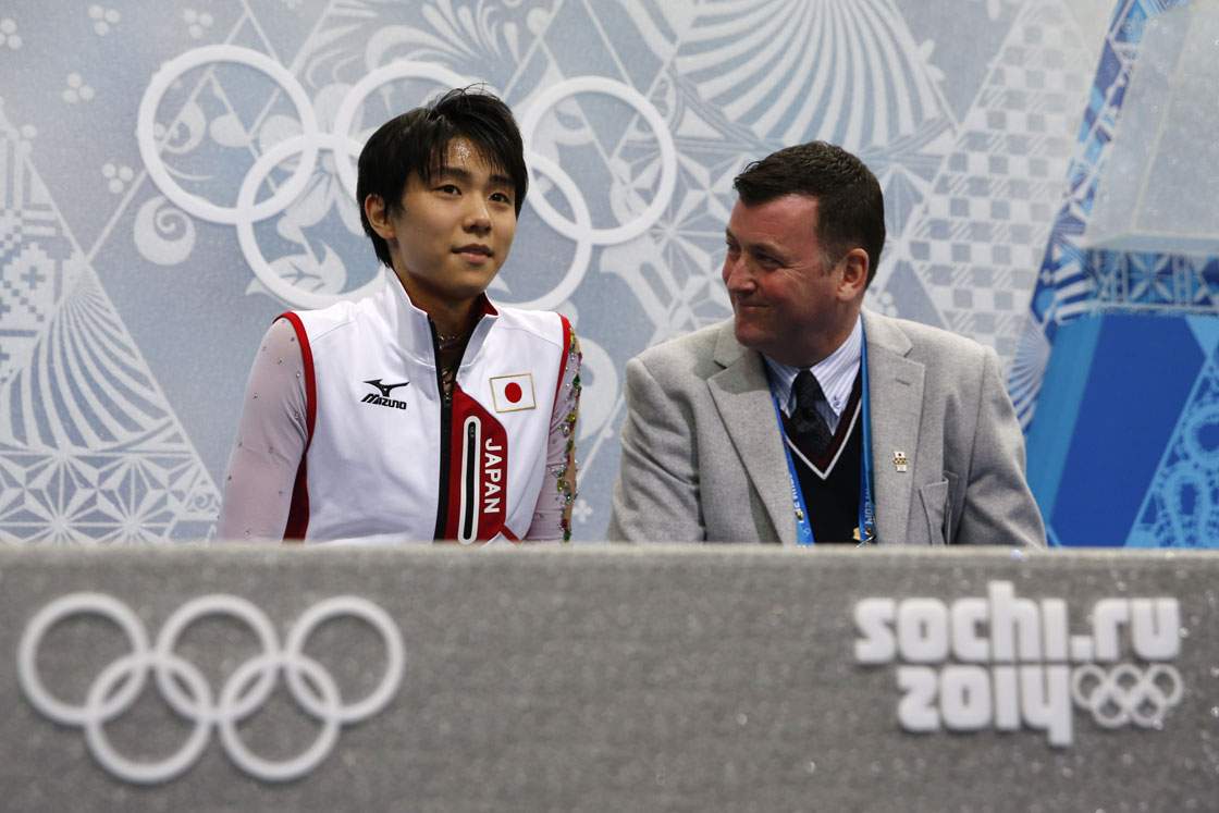 Brian Orser, the men's ice skating silver medalist in the 1988 Winter Olympics, sits beside Yuzuru Hanyu, the 2014 gold medalist.