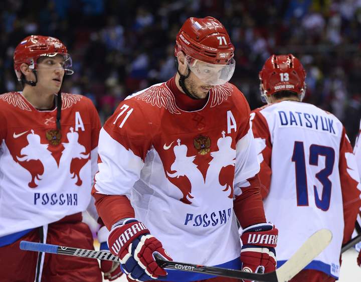 Russia’s Alexander Ovechkin (L) reacts as Finland’s players celebrate a 3-1 victory at the end of the Men’s Ice Hockey Play-offs Quarterfinals match between Finland and Russia at the Bolshoy Ice Dome during the Sochi Winter Olympics on Feb. 19, 2014.   (Photo credit: Johnathan Nackstand/Getty Images)