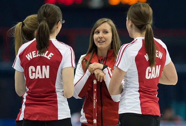 Team Canada skip Rachel Homan chats with teammates, from left, Alison Kreviazuk, Lisa Weagle and Emma Miskew while taking a break during their draw against team Ontario at the Scotties Tournament of Hearts in Montreal on Sunday.