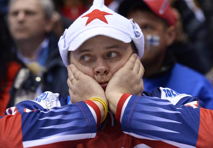 A Russian supporter reacts during the Men’s Ice Hockey Play-offs Quarterfinals match between Finland and Russia at the Bolshoy Ice Dome during the Sochi Winter Olympics on Feb. 19, 2014. (Photo credit: Johnathan Nackstand/Getty Images)