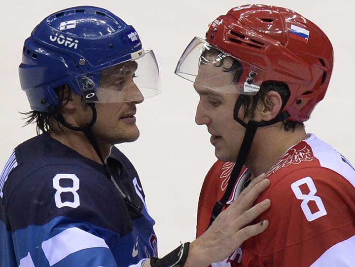 Russia’s Alexander Ovechkin (R) talks to Finland’s Teemu Selanne at the end of the Men’s Ice Hockey Play-offs Quarterfinals match between Finland and Russia at the Bolshoy Ice Dome during the Sochi Winter Olympics on Feb. 19, 2014. (Photo credit: Alexander Nemenov/Getty Images)