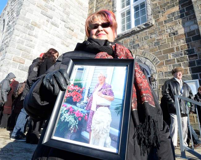 Marie Caron holds a photo of her aunt Jacqueline Caron, 89, one of the victims of the seniors' residence fire in L'Isle-Verte, Que.