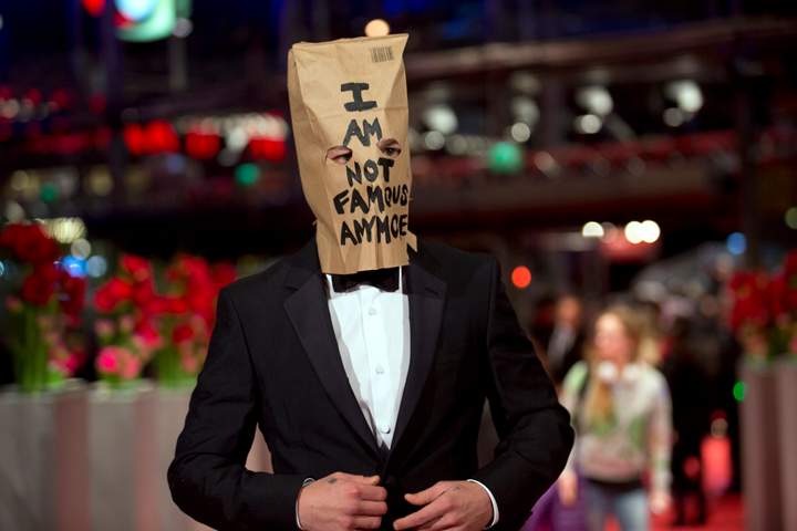 Actor Shia LaBeouf poses for photographers at the Berlin Film Festival with a paper bag over his head that says ‘I am not famous anymore.’