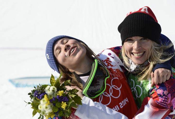 Gold Medallist, Czech Republic’s Eva Samkova (L) celebrates with Silver Medallist, Canada’s Dominique Maltais during the Women’s Snowboard Cross Flower Ceremony at the Rosa Khutor Extreme Park during the Sochi Winter Olympics on February 16, 2014. (Franck Fife/AFP/Getty Images)