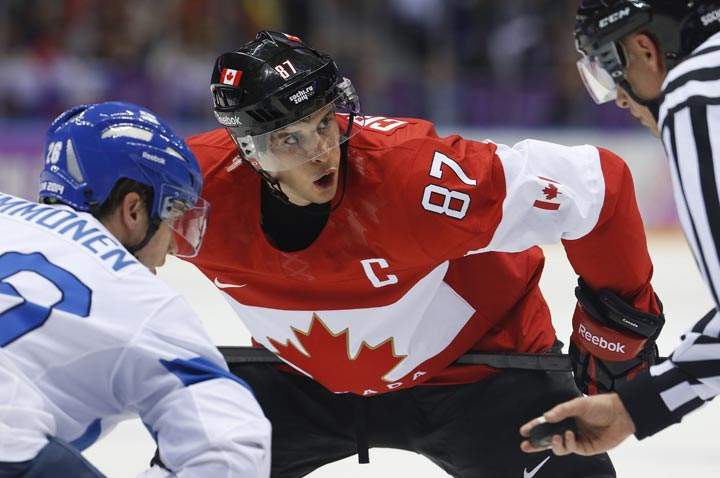 Canada forward Sidney Crosby watches the official during a face-off against Finland forward Jarkko Immonen in the first period of a men’s ice hockey game at the 2014 Winter Olympics, Sunday, Feb. 16, 2014, in Sochi, Russia. (AP Photo/Mark Humphrey)