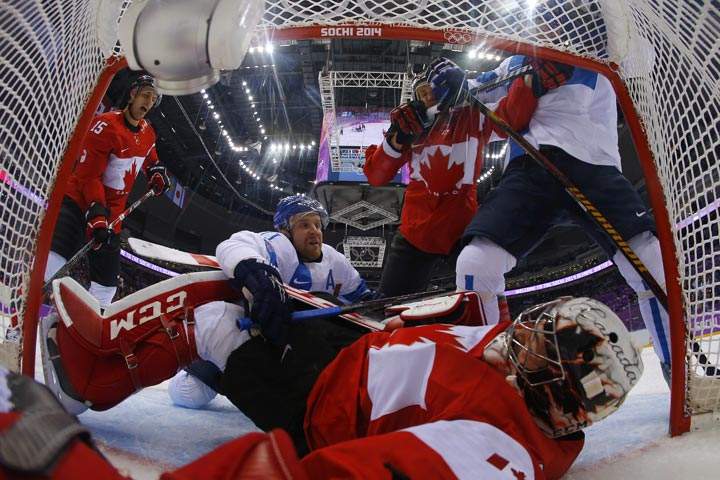 Finland’s Leo Komarov (2ndL) tries to score against Canada’s goalkeeper Carey Price during the Men’s Ice Hockey Group B match Finland vs Canada at the Bolshoy Ice Dome during the Sochi Winter Olympics on February 16, 2014 in Sochi. (Mark Blinch/AFP/Getty Images)