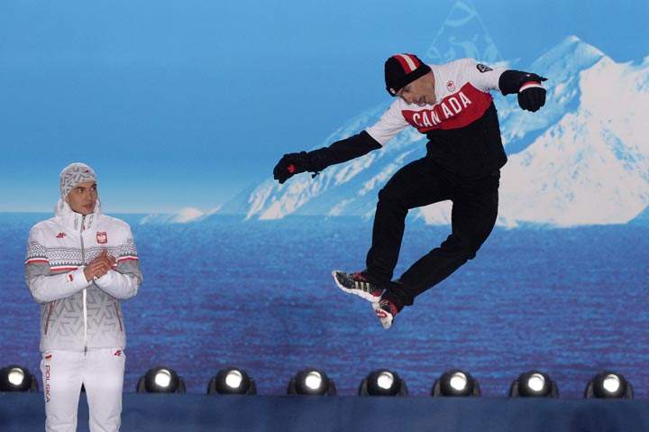 A picture taken with a robotic camera shows (from L) Poland’s gold medalist Zbigniew Brodka and Canada’s bronze medalist Denny Morrison posing during the Men’s Speed Skating 1500m Medal Ceremony at the Sochi medals plaza during the Sochi Winter Olympics on February 16, 2014. (Antonin Thuillier/AFP/Getty Images)
