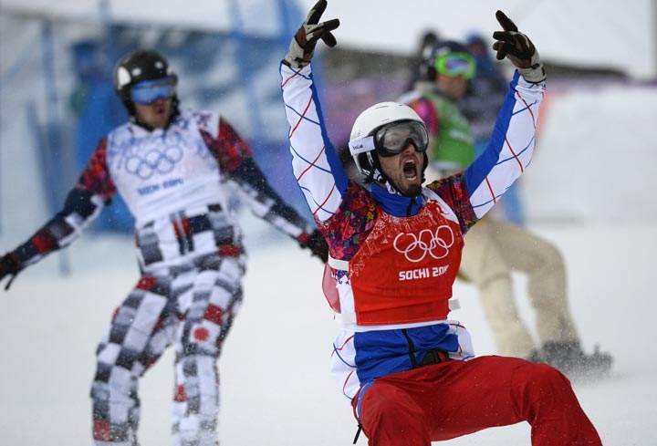 France’s Pierre Vaultier celebrates his Gold Medal ahead of Russia’s Nikolay Olyunin (L) and US Alex Deibold (R)in the Men’s Snowboard Cross Final at the Rosa Khutor Extreme Park during the Sochi Winter Olympics on February 18, 2014. (Lionel Bonaventure/AFP/Getty Images)