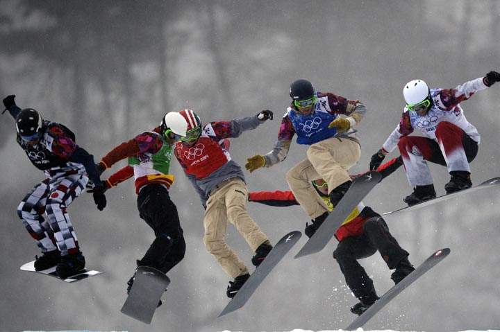 Snowboarders race in Heat 13 in the Men’s Snowboard Cross Semifinals at the Rosa Khutor Extreme Park during the Sochi Winter Olympics on February 18, 2014. (Franck Fife/AFP/Getty Images)