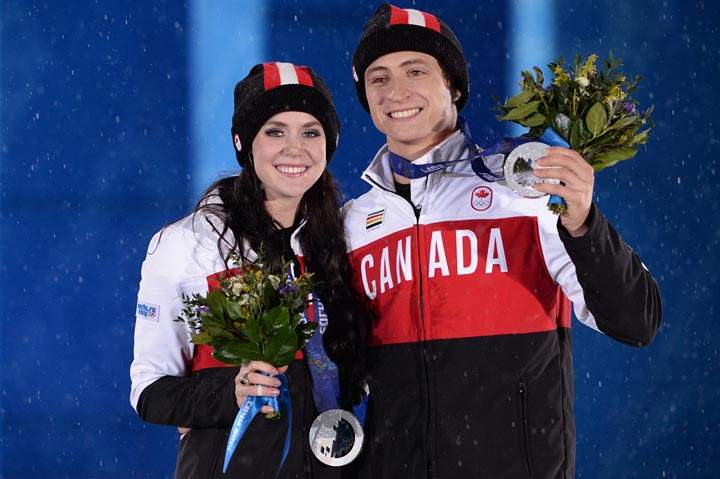 Canada’s silver medalists Tessa Virtue and Scott Moir pose during the Figure Skating Ice Dance Medal Ceremony at the Sochi medals plaza during the Sochi Winter Olympics on February 18, 2014. (Andrej Isakovic/AFP/Getty Images)