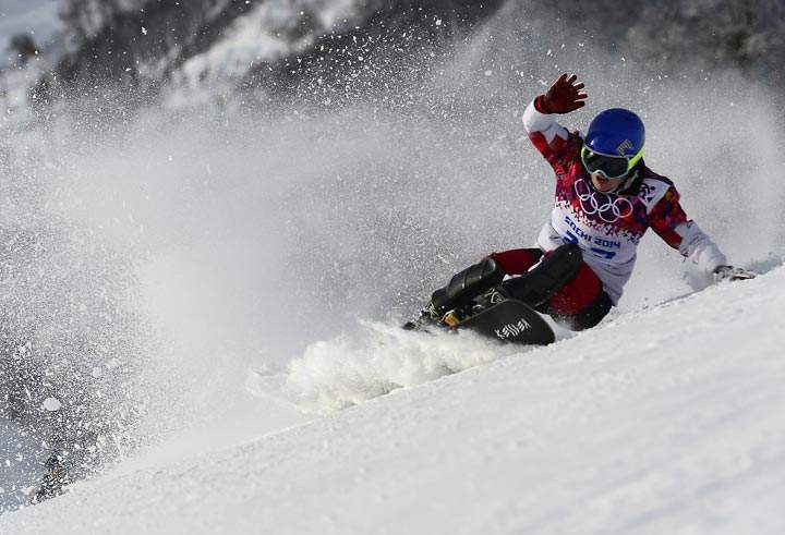 Canada’s Michael Lambert crashes in the Men’s Snowboard Parallel Giant Slalom qualification run at the Rosa Khutor Extreme Park during the Sochi Winter Olympics on February 19, 2014. (Javier Soriano/AFP/Getty Images)