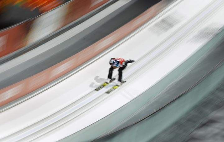 An unidentified athlete makes an attempt in the men’s normal hill ski jumping training at the 2014 Winter Olympics, Thursday, Feb. 6, 2014, in Krasnaya Polyana, Russia. (AP Photo/Matthias Schrader)
