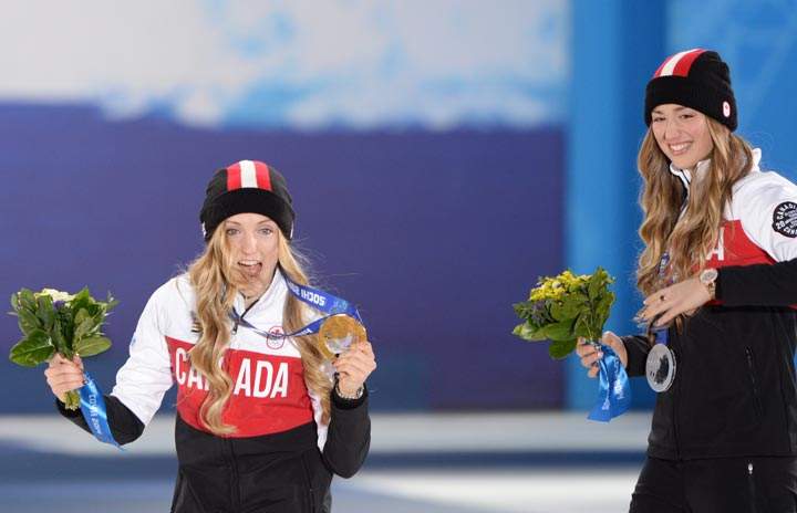A picture taken with a robotic camera shows Canada’s silver medalist Chloe Dufour-Lapointe and Canada’s gold medalist Justine Dufour-Lapointe posing during the Women’s Freestyle Skiing Moguls Medal Ceremony at the Sochi medals plaza during the Sochi Winter Olympics on February 9, 2014. (Antonin Thuillier/AFP/Getty Images)