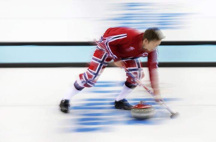 Norway’s Torger Nergaard sweeps the ice during a men’s curling training session at the 2014 Winter Olympics, Sunday, Feb. 9, 2014, in Sochi, Russia. (AP Photo/Wong Maye-E)