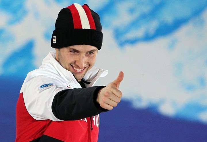 Canada's gold medalist Alex Bilodeau celebrates on the podium during the Men's Freestyle Skiing Moguls Medal Ceremony at the Sochi medals plaza during the Sochi Winter Olympics on February 11, 2014.  
