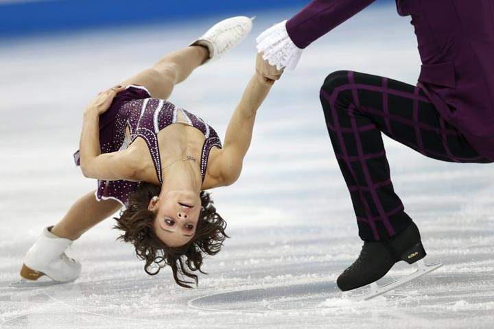 Canada’s Meagan Duhamel and Canada’s Eric Radford perform their Figure Skating Pairs Free Program at the Iceberg Skating Palace during the Sochi Winter Olympics on February 12, 2014. (Adrian Dennis/AFP/Getty Images)