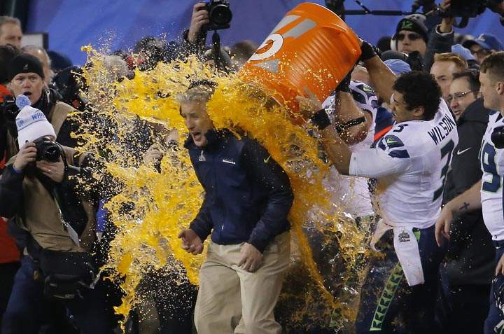 Seattle Seahawks quarterback Russell Wilson dumps Gatorade on head coach Pete Carroll late in the game against the Denver Broncos during the second half of the NFL Super Bowl XLVIII football game Sunday, Feb. 2, 2014, in East Rutherford, N.J. Seattle won 43-8. (AP Photo/Matt York)
