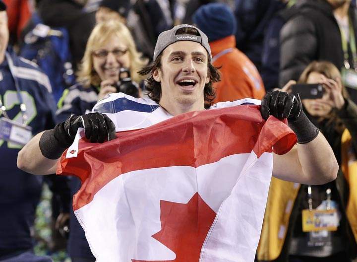 Seattle Seahawks tight end Luke Willson holds up a Canadian flag after the NFL Super Bowl XLVIII football game against the Denver Broncos, Sunday, Feb. 2, 2014, in East Rutherford, N.J. The Seahawks won 43-8. (AP Photo/Kathy Willens)