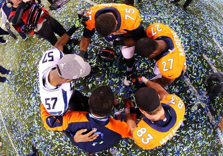 Outside linebacker Mike Morgan of the Seattle Seahawks gathers with Broncos players after Super Bowl XLVIII at MetLife Stadium on February 2, 2014 in East Rutherford, New Jersey. The Seahawks beat the Broncos 43-8. (Jamie Squire/Getty Images)