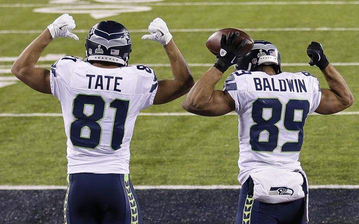 Seattle Seahawks wide receiver Golden Tate and wide receiver Doug Baldwin pump their arms in celebration after a touchdown run by Baldwin during the second half of the NFL Super Bowl XLVIII football game against the Denver Broncos Sunday, Feb. 2, 2014, in East Rutherford, N.J. (AP Photo/Gregory Bull)