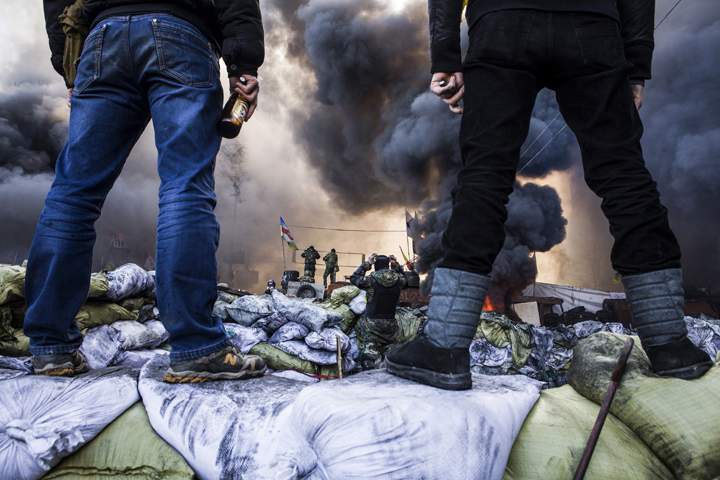 Anti-government demonstrators stand on barricades during clashes with riot police in Kyiv on Feb. 8, 2014. (Photo credit: Sandro Maddalena/Getty Images)