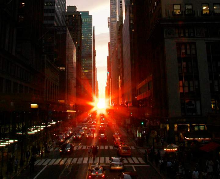 The sun is seen as it sets between Manhattan buildings on 42nd Street during a phenomenon known as "Manhattanhenge," , July 13, 2011. 