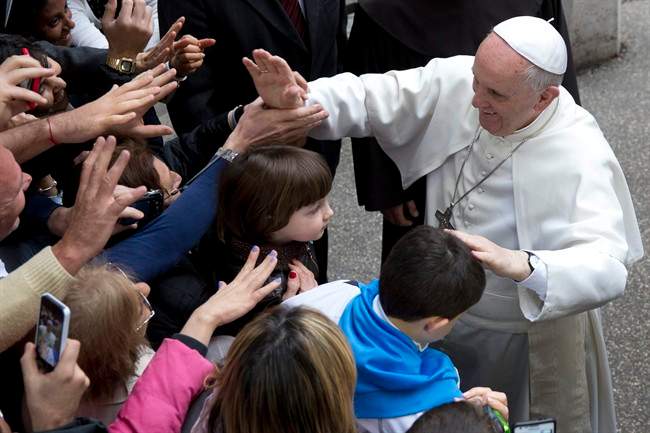 Pope Francis greets faithful as he arrives for a meeting with relatives of innocent mafia victims, in Rome's St. Gregorio VII church, just outside the Vatican, Friday, March 21, 2014. (AP Photo/Andrew Medichini).