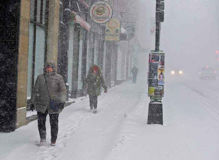 .Pedestrians battle high winds and blowing snow as they walk in downtown Halifax on Wednesday, March 26, 2014