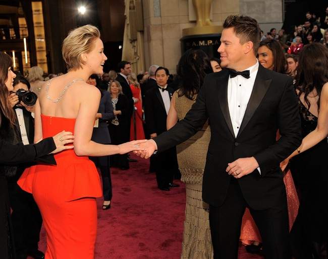 Jennifer Lawrence, left, and Channing Tatum shake hands at the Oscars on Sunday, March 2, 2014, at the Dolby Theatre in Los Angeles.