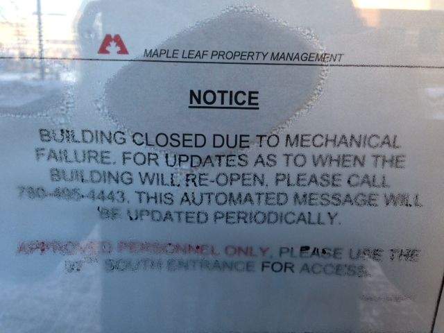 A note has been posted on one of the doors at Edmonton’s Canada Place building, informing people about the building’s closure.
