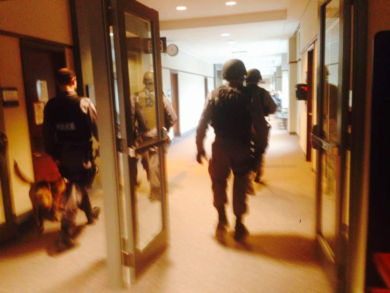 Tactical police officers search the courthouse moments after the shooting. March 28, 2014