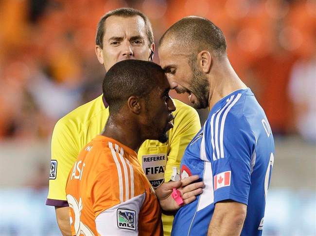 Houston Dynamo midfielder Corey Ashe has words with Montreal Impact forward Marco Di Vaio.