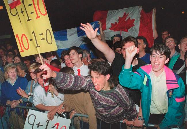 Demonstrators show their support for the Meech Lake Accord as the premiers leave the conference centre breaking off for the day at the constitutional talks in Ottawa in a June 6, 1990 file photo. 