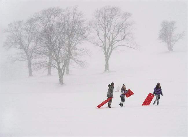 Young people take advantage of school cancellations due to the weather as they slide on Citadel Hill in Halifax on Wednesday, Jan. 22, 2014. Although the calendar says it's spring, Atlantic Canada is not getting a reprieve from the winter weather.