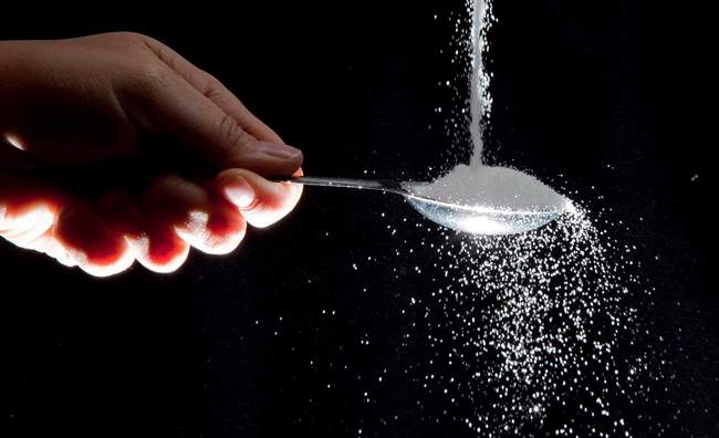 Sugar is poured on a tablespoon in a photo illustration in North Vancouver, B.C. Wednesday, Sept. 21, 2011.