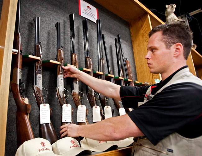 Patrick Deegan, a senior range officer, displays long guns at a gun store in Calgary, Wednesday, Sept. 15, 2010 in a photo taken to illustrate the debate at the time on Canada's long gun registry.
